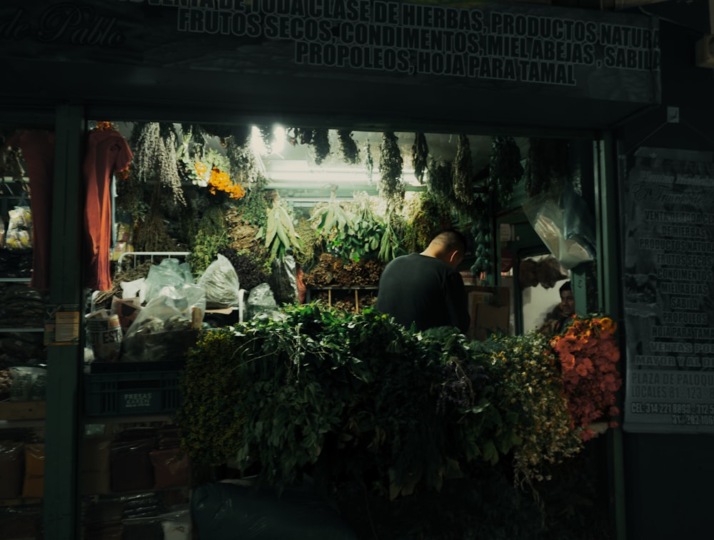a man standing in front of a flower shop