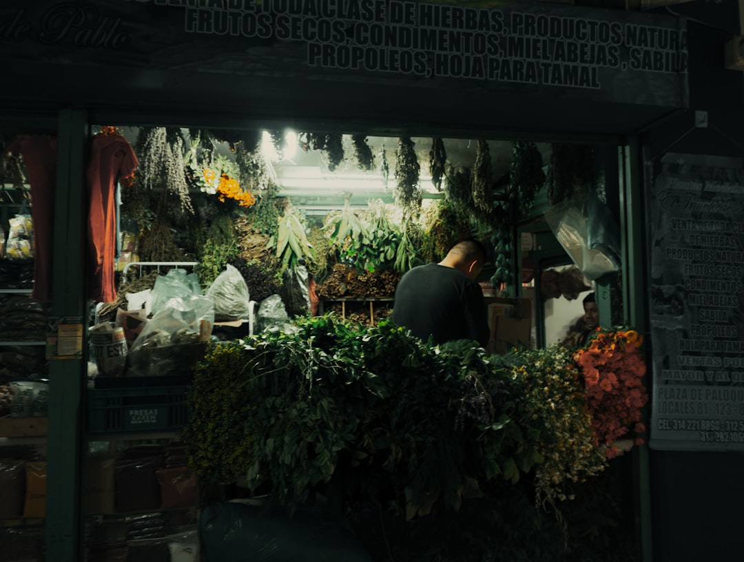 a man standing in front of a flower shop,