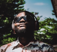 a man wearing headphones and a tie dye shirt