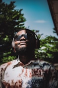 a man wearing headphones and a tie dye shirt