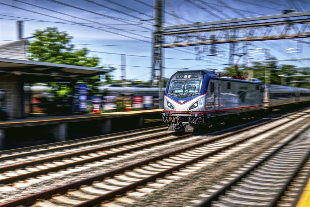 a train traveling down train tracks next to a station