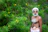 Portrait of an indigenous man standing confidently in a lush tropical forest.