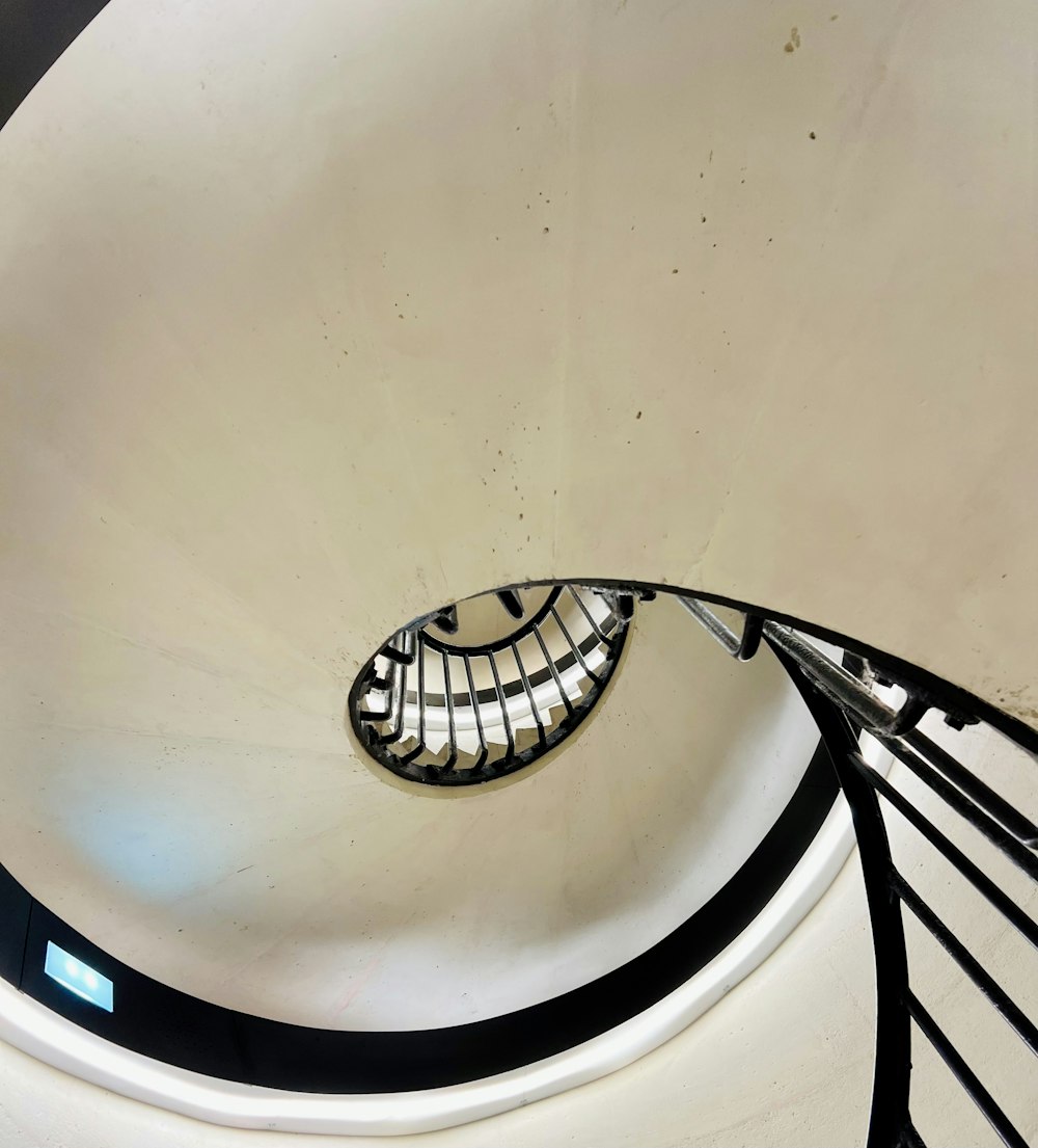 a spiral staircase in a building with a skylight