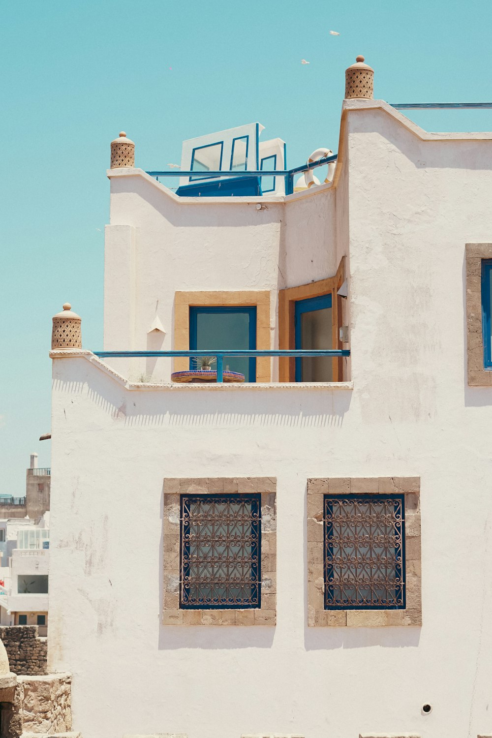 a white building with two windows and a [UNK]