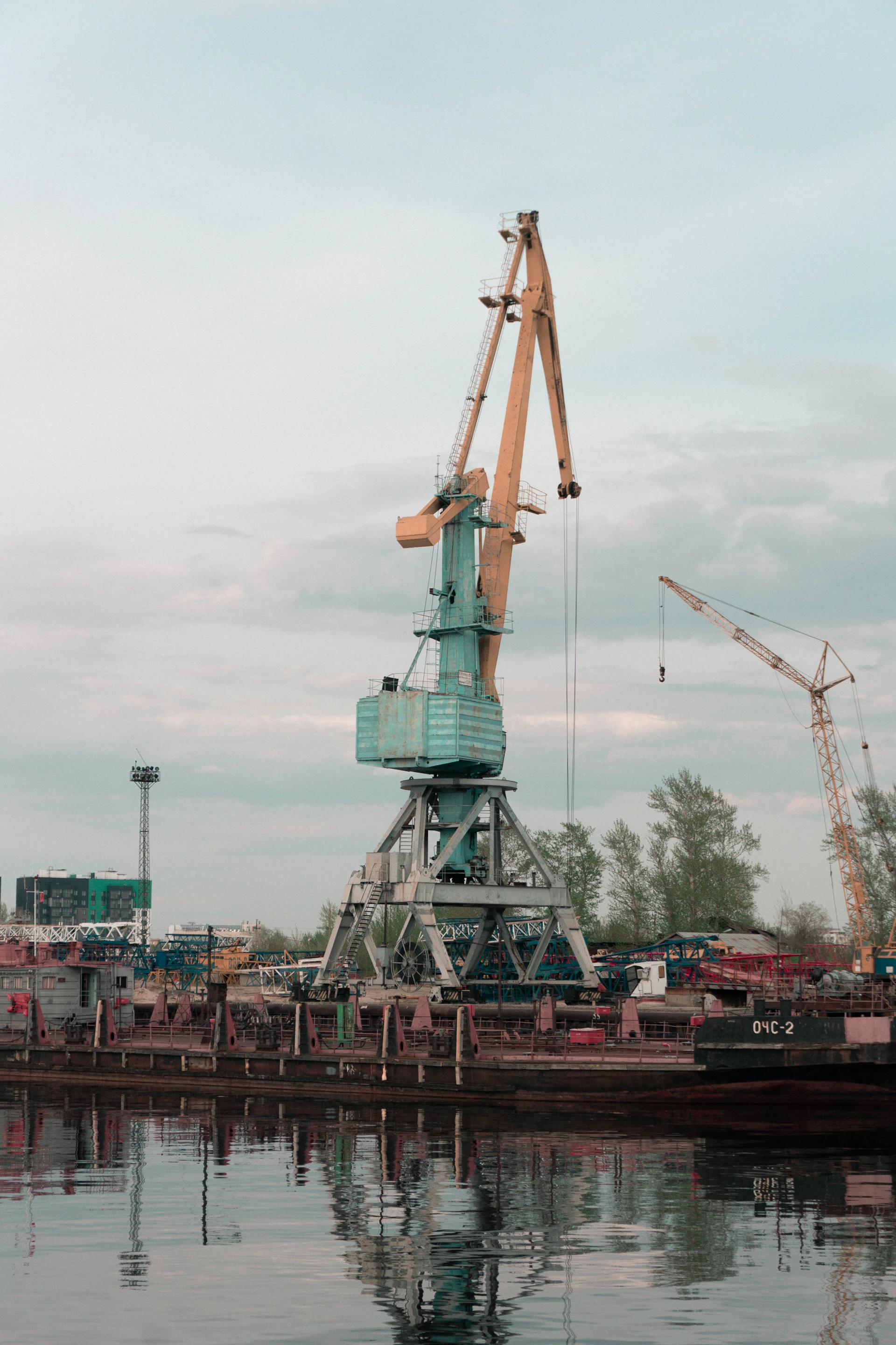 a large crane sitting on top of a body of water