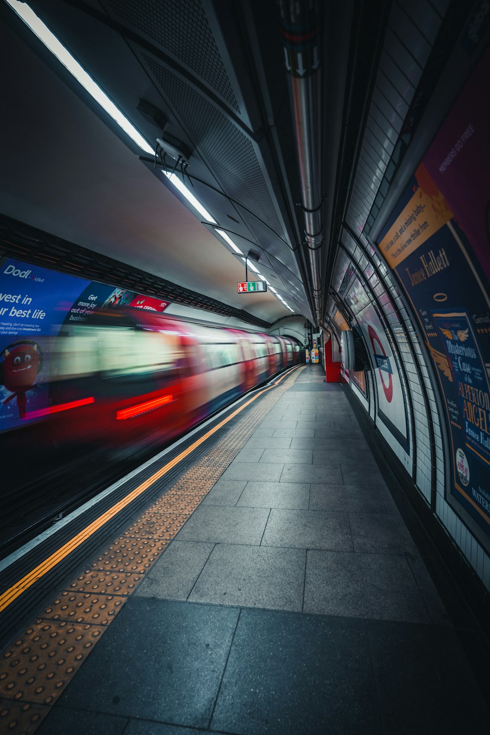 a train traveling through a train station next to a platform