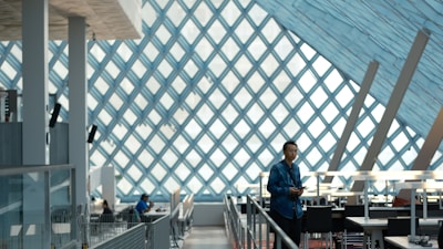 a man standing in a room with a glass wall