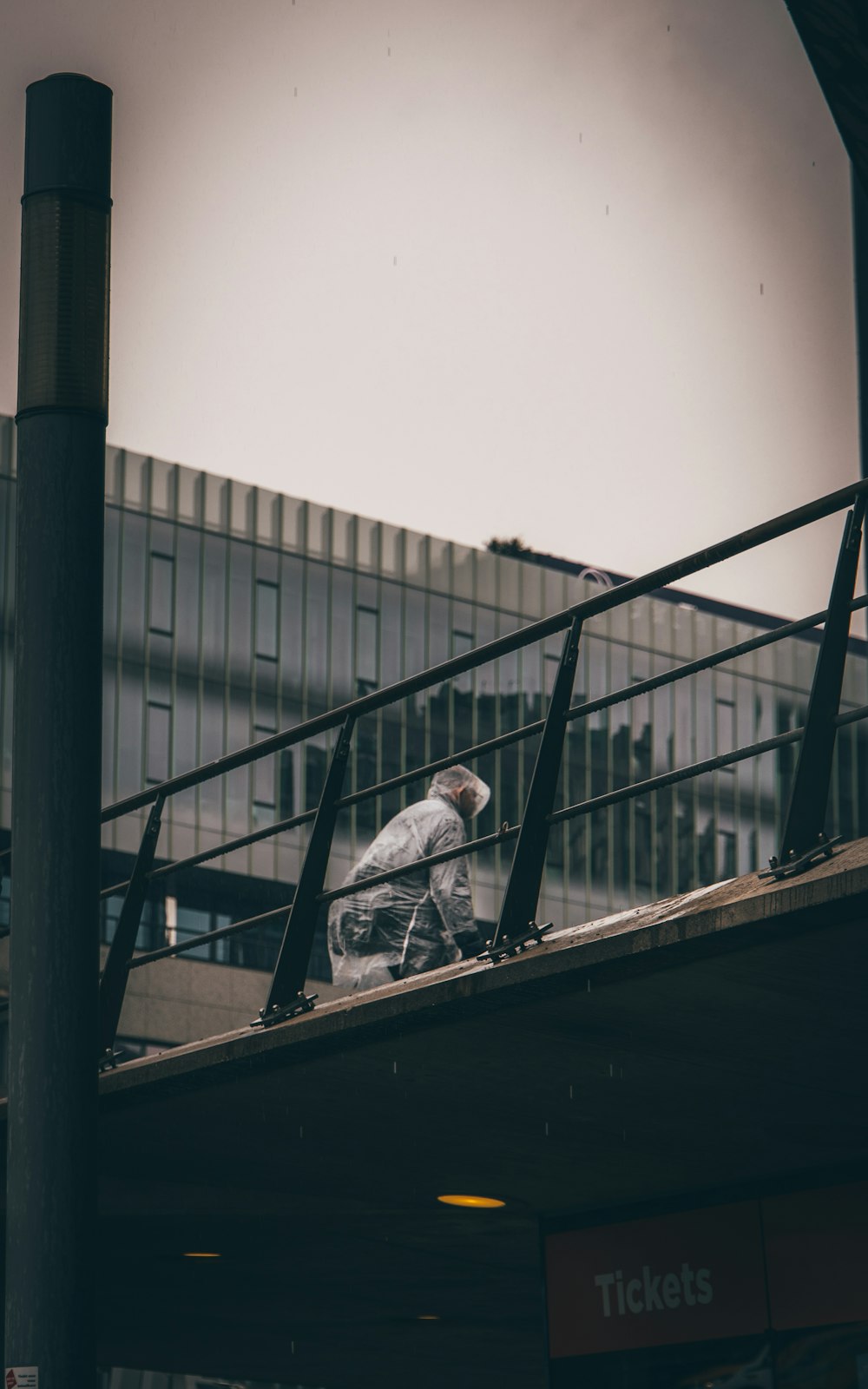 a man [UNK] a [UNK] [UNK] down a metal hand rail