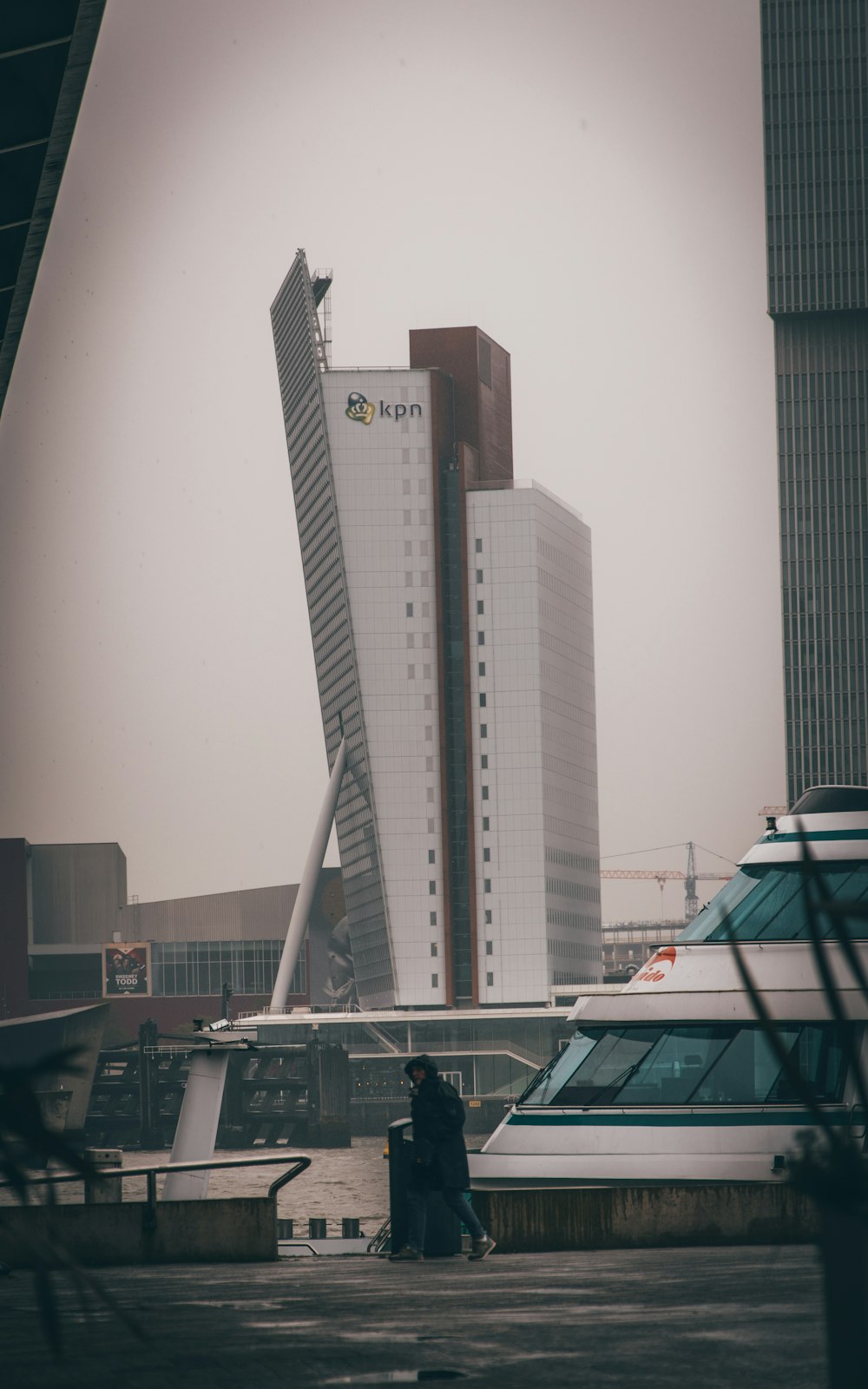 a tall building sitting next to a body of water