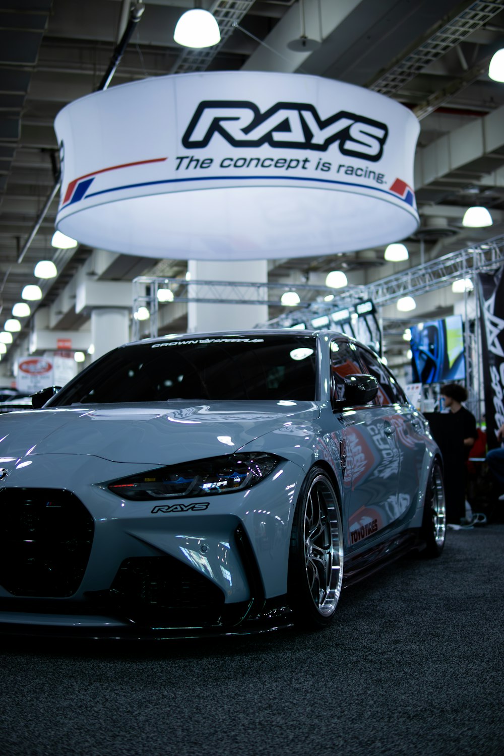 a gray sports car parked in a showroom