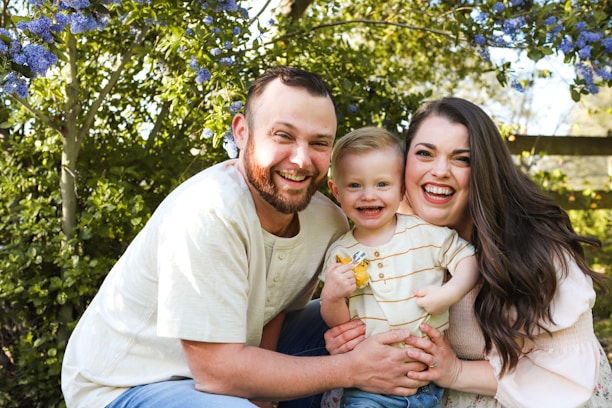 A cheerful family wearing matching outfits in a sunny park setting.