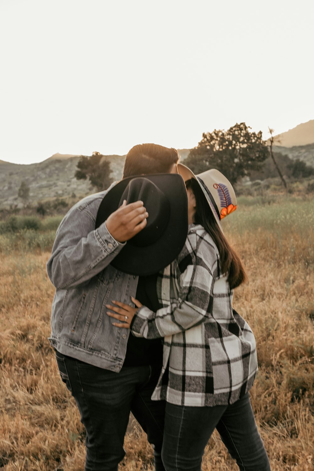 a couple of people that are standing in the grass