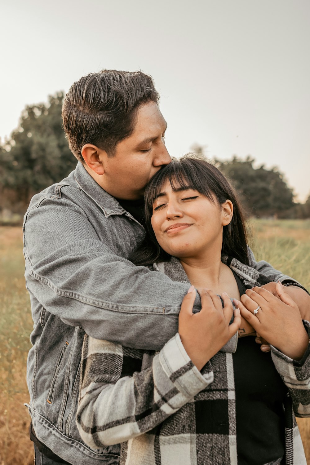 a man hugging a woman in a field