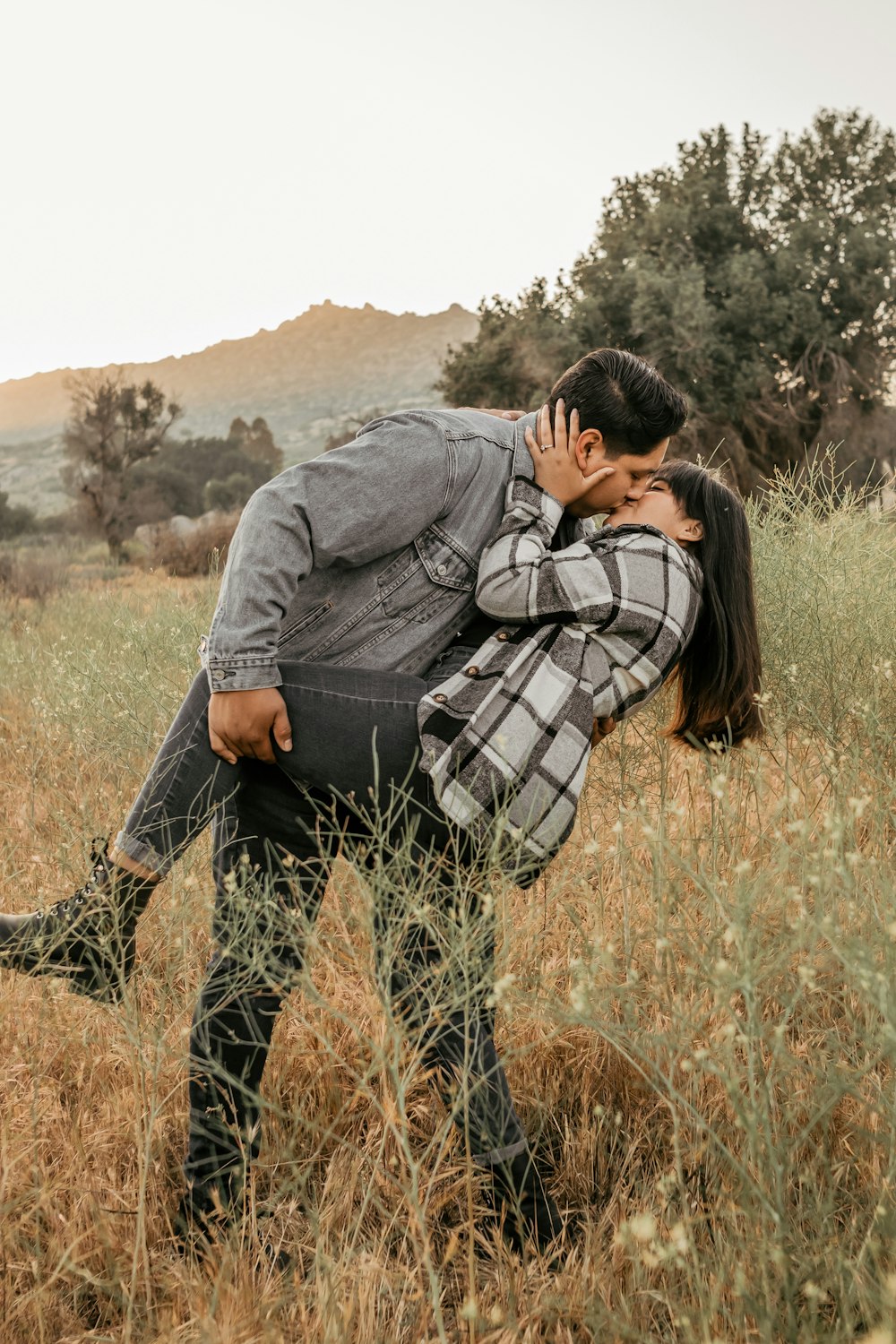 a man and a woman [UNK] in a field