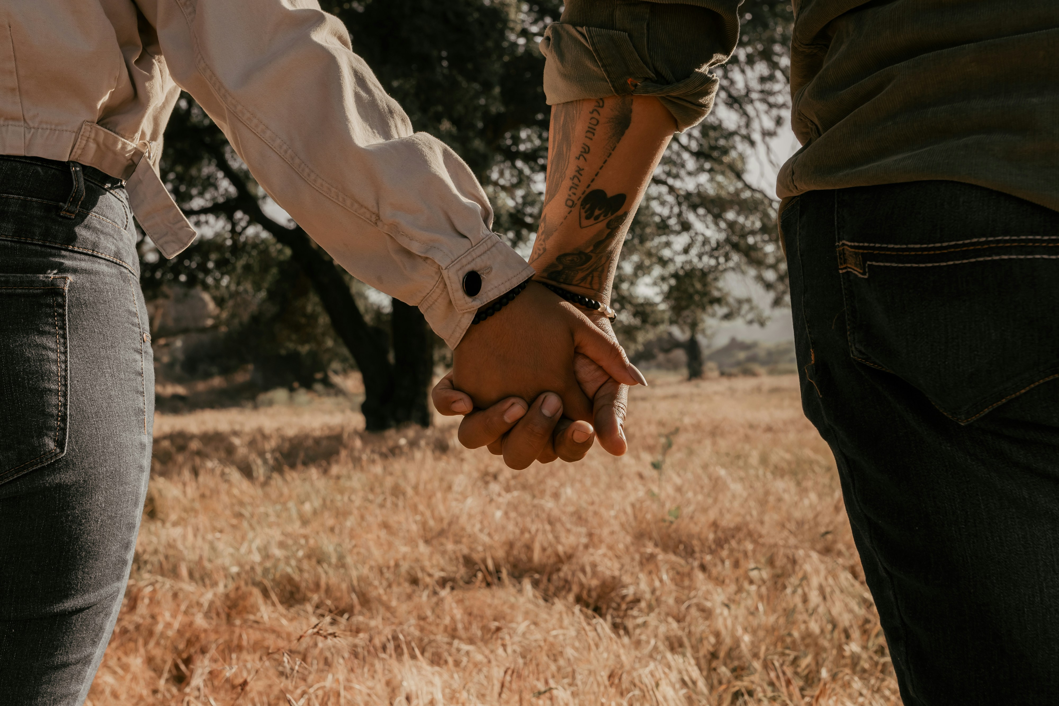 a close up of two people holding hands