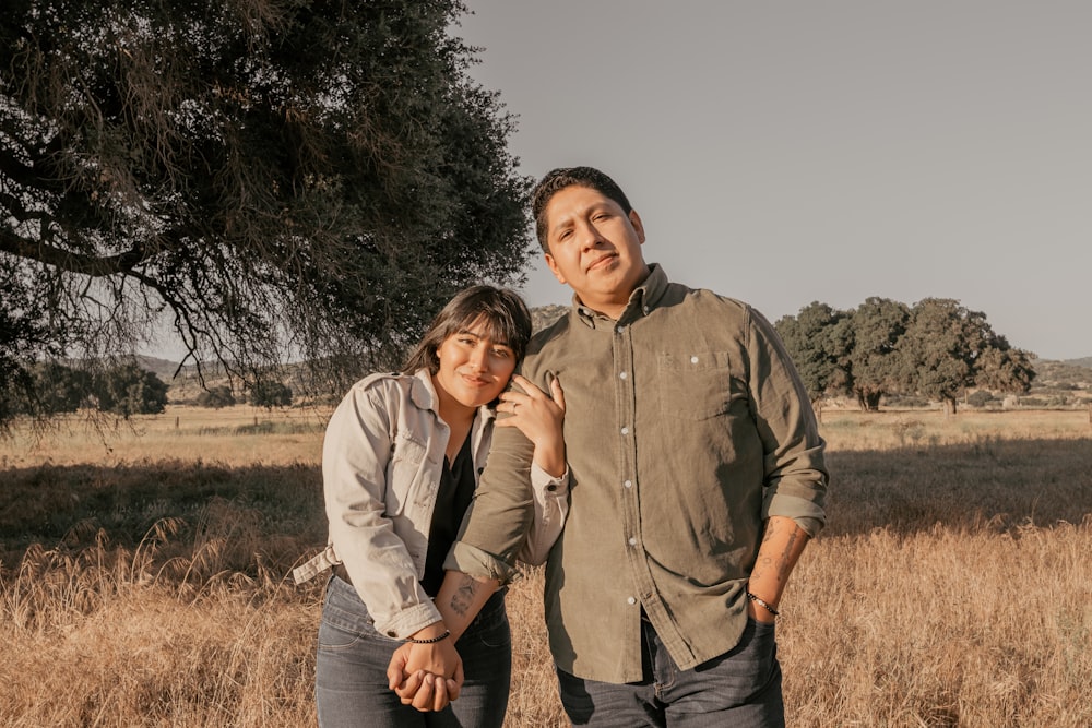 a man and a woman standing in a field