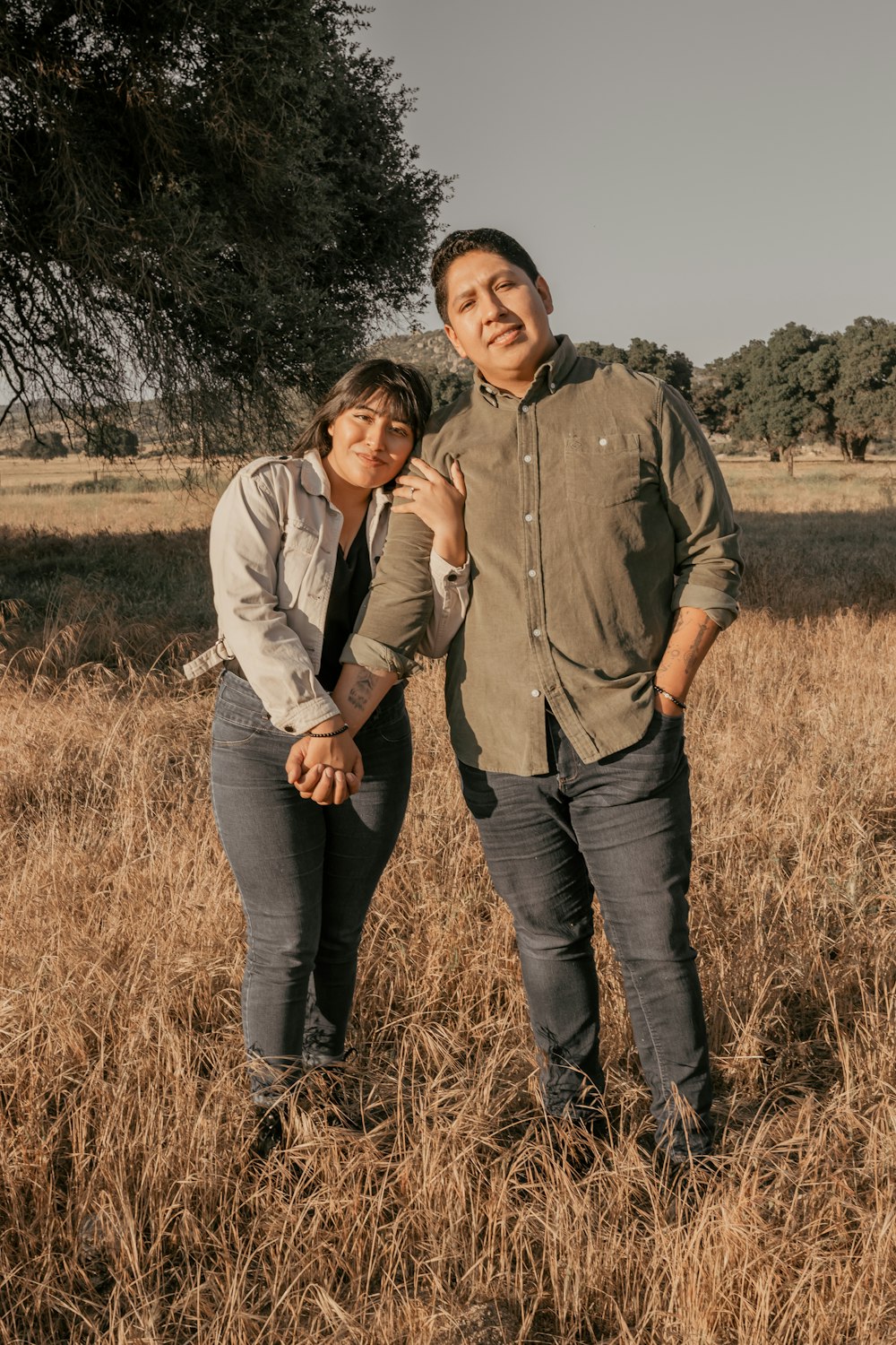 a man and a woman standing in a field