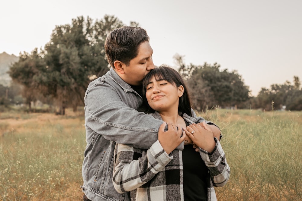 a man and a woman embracing in a field