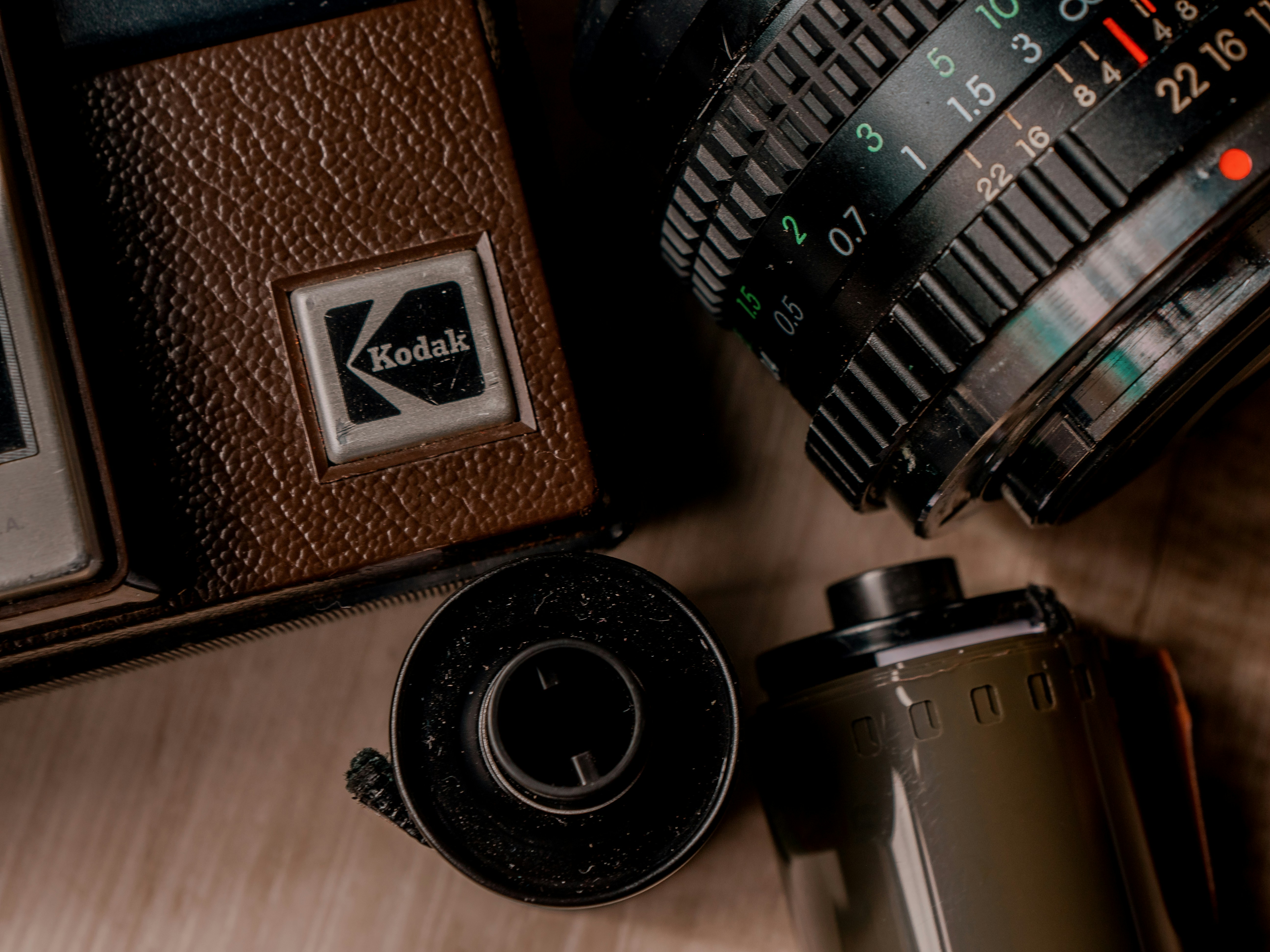 a camera, a camera lens, and a camera case on a table