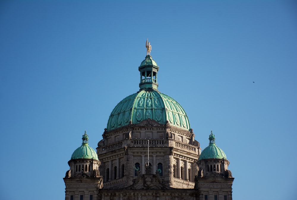 the top of a building with a green dome