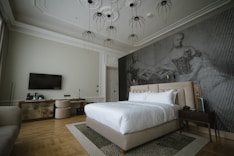 a [UNK] with a large bed and a tv on the wall