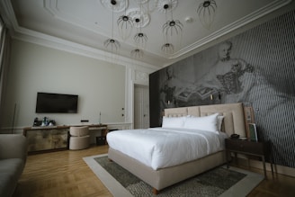 A spacious bedroom with a comfortable bed and desk.