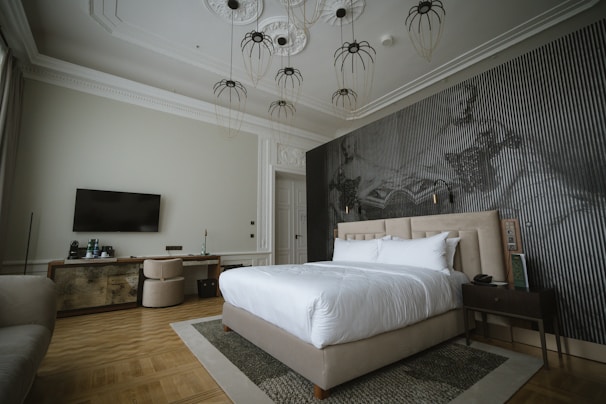 Bright, fully furnished private bedroom featuring a TV and clean linens.