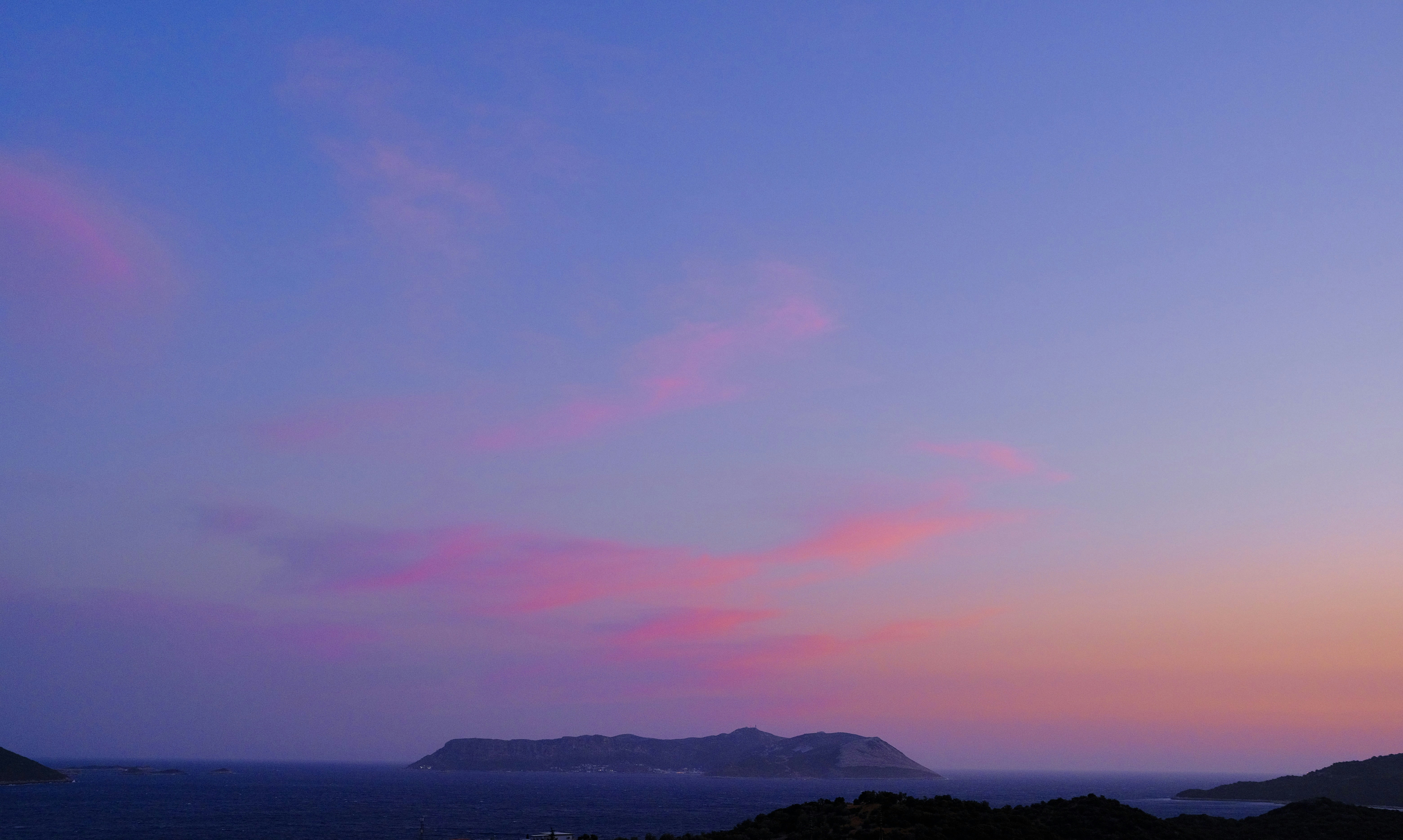 a pink and blue sky over a body of water, 