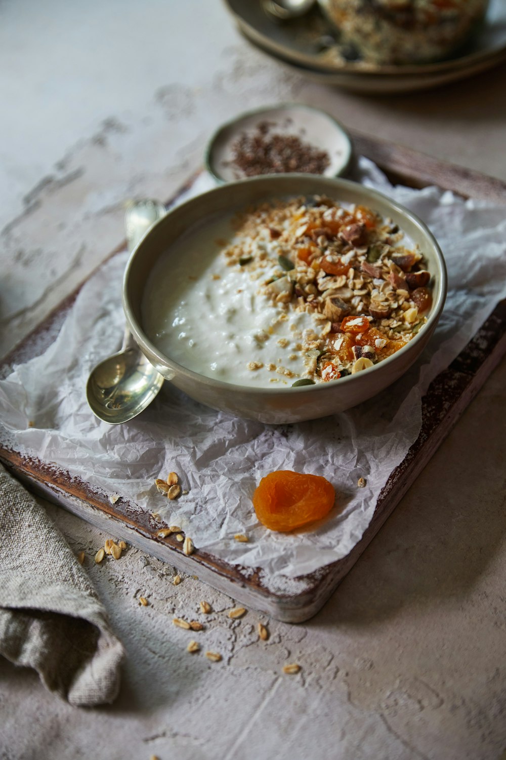 a bowl of oatmeal and a spoon on a table