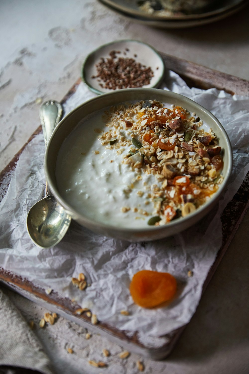 a bowl of oatmeal and a spoon on a napkin