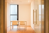 A calm, elegant meeting room with minimalist decor and soft lighting.