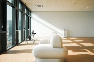 a white couch sitting in the middle of a room