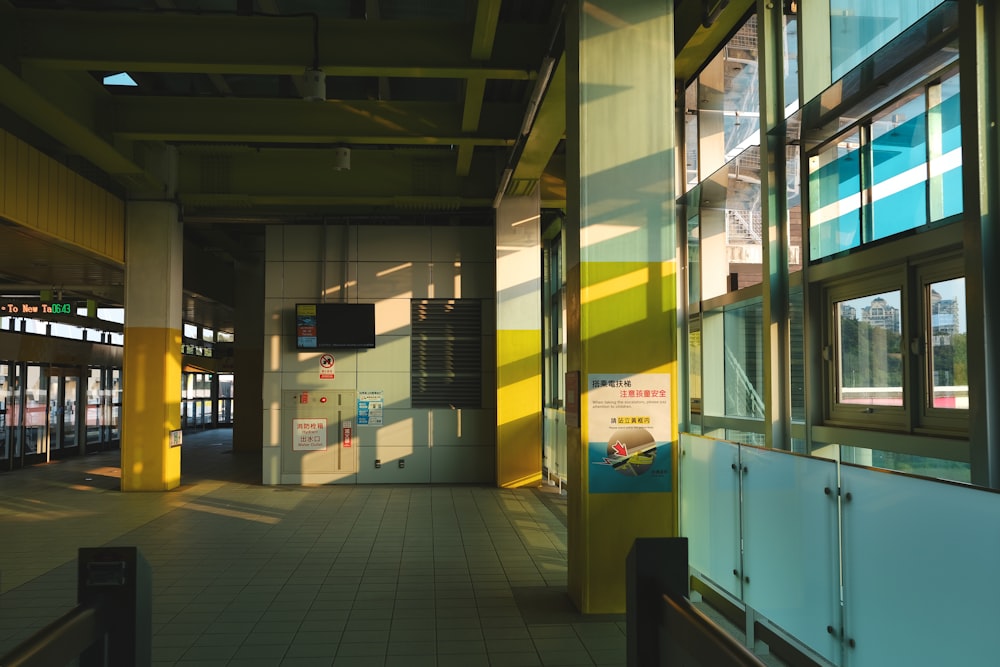 an empty train station with the sun shining through the windows