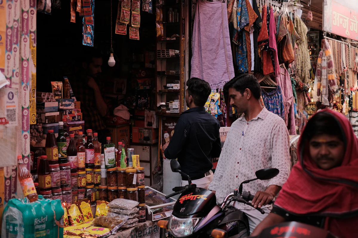 A motorcycle passing through a busy market lane