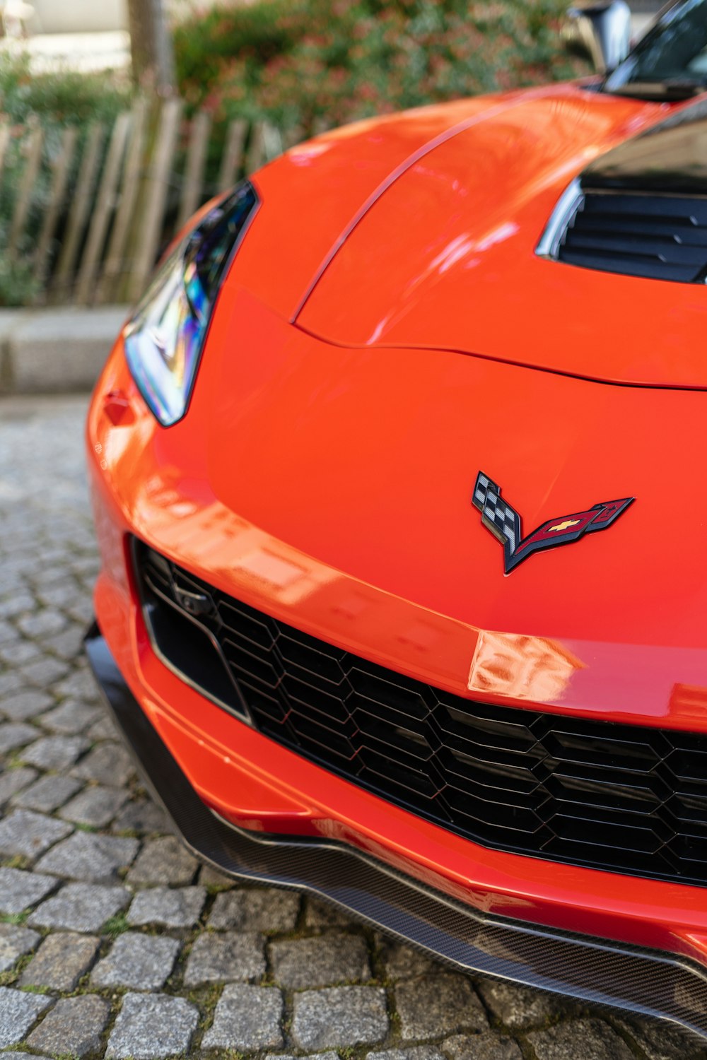 a close up of the front of a red sports car