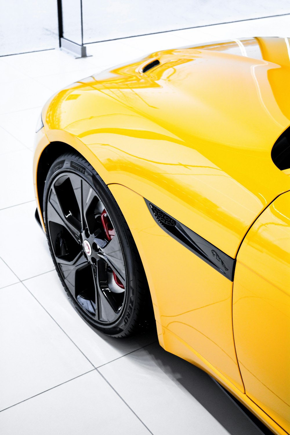 a yellow sports car parked in a showroom