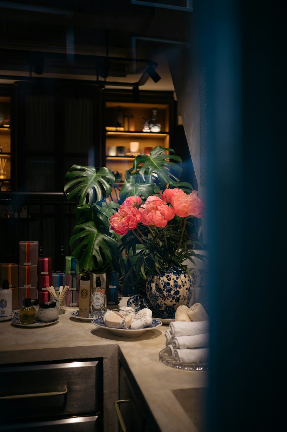 a vase of flowers on a counter in a kitchen