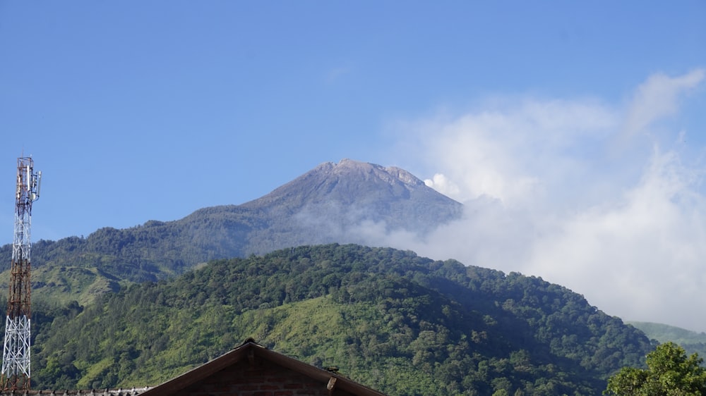 a view of a mountain with a radio tower in the foreground