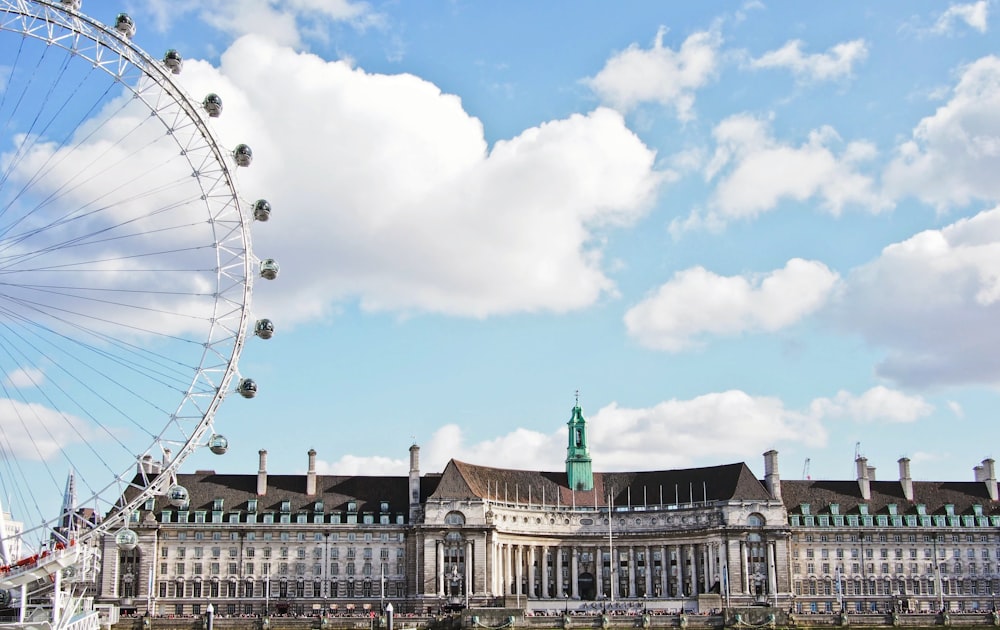 a large building with a ferris wheel in front of it