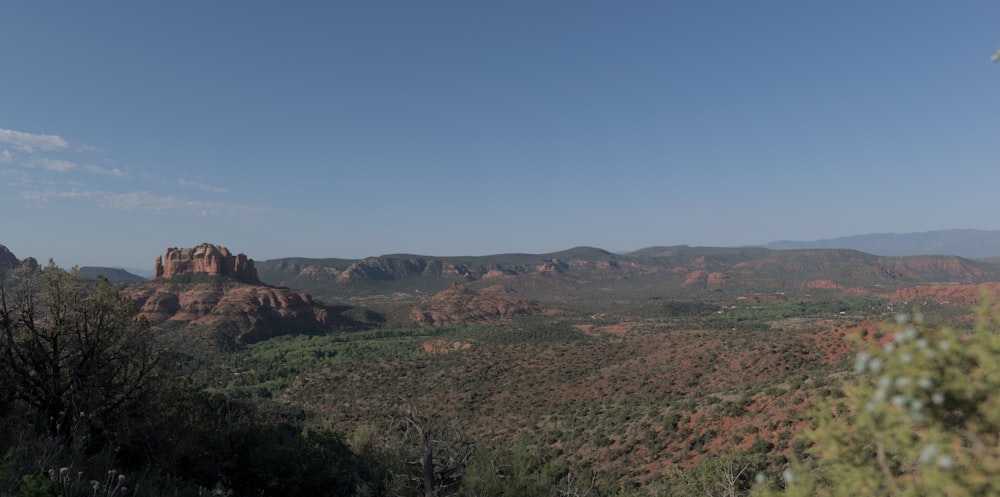 a view of a mountain range with trees and mountains in the background