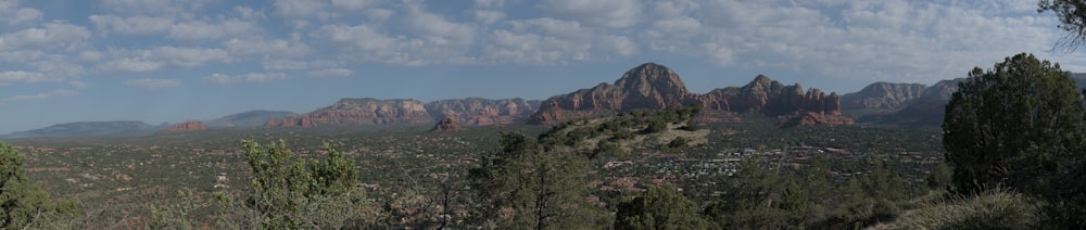 a view of a mountain range with clouds in the sky