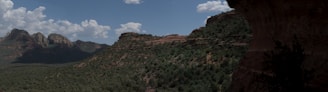 A panoramic shot of Ravana's Cave surrounded by greenery.