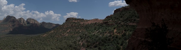 A panoramic shot of Ravana's Cave surrounded by greenery.