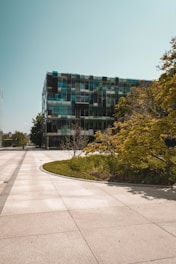 Modern commercial building with glass facade and landscaped surroundings.