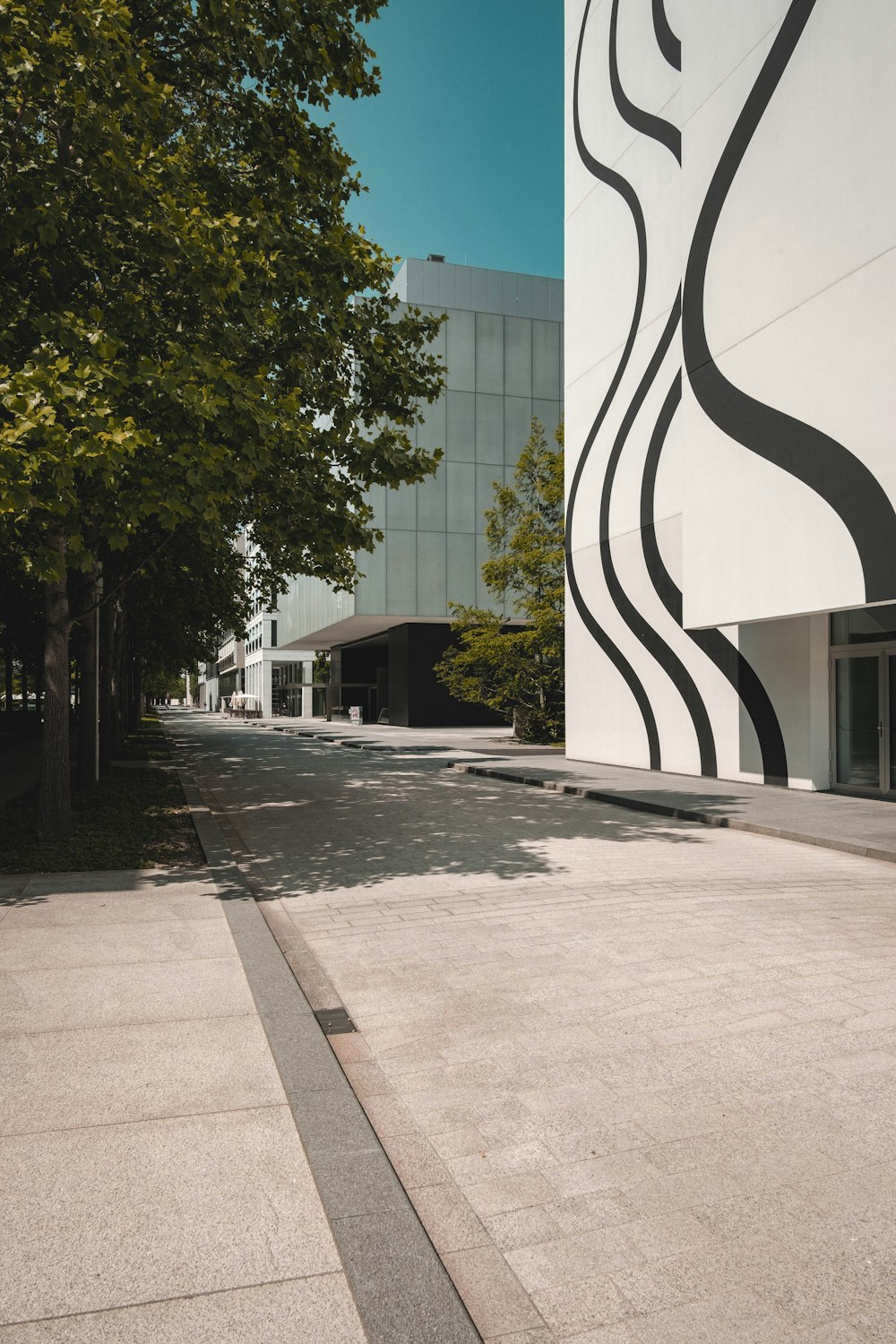 an empty street with a building in the background