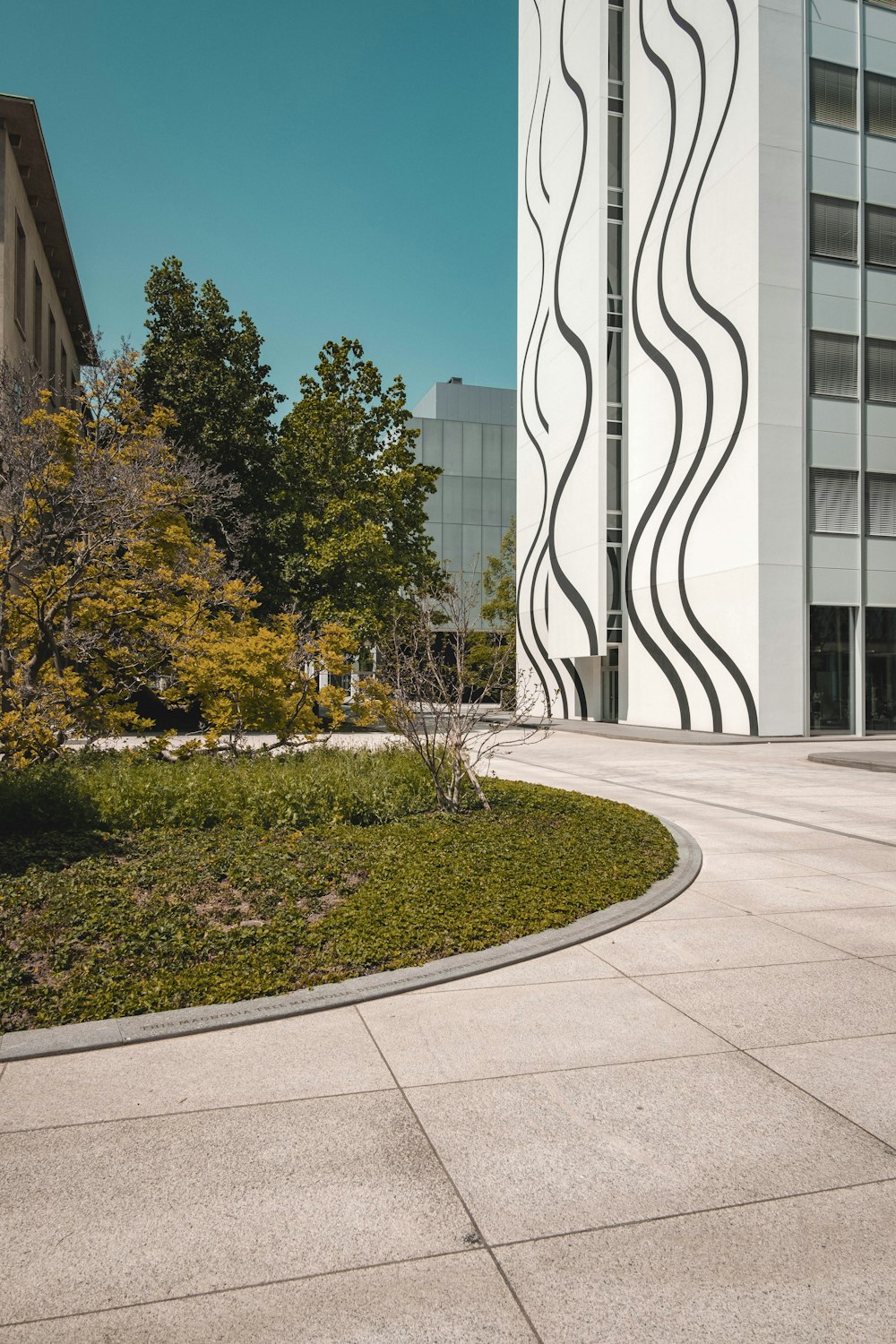 a building with a curved walkway in front of it