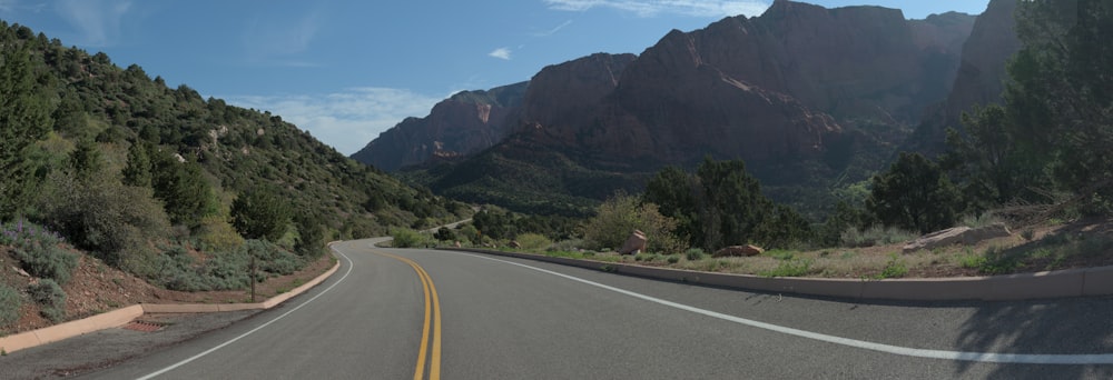 a view of a road with mountains in the background