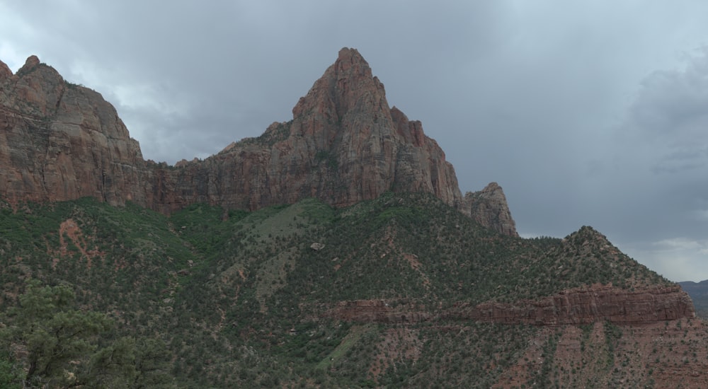 a mountain range with a cloudy sky in the background