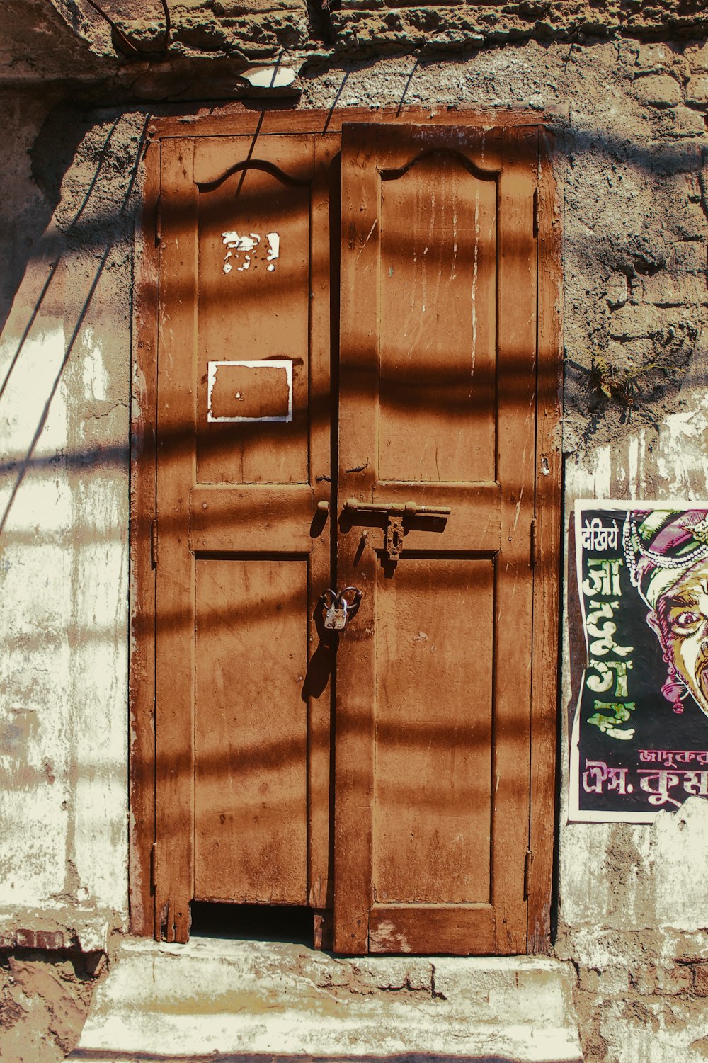 an old door with a poster on the side of it
