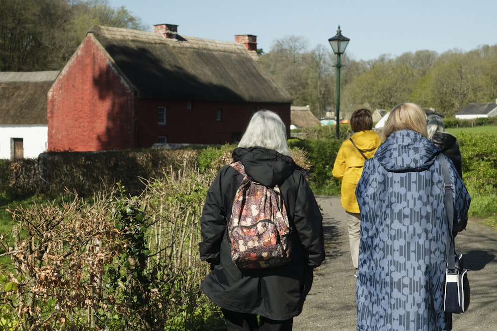 a group of people walking down a dirt road